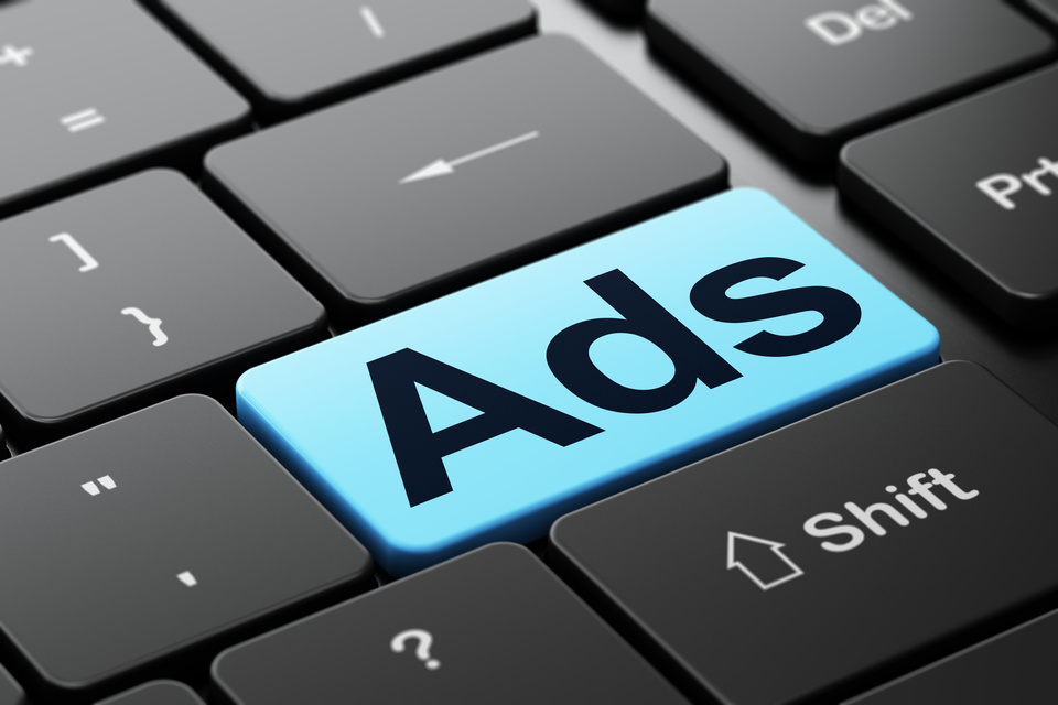 Marketing concept: Ads on computer keyboard background
